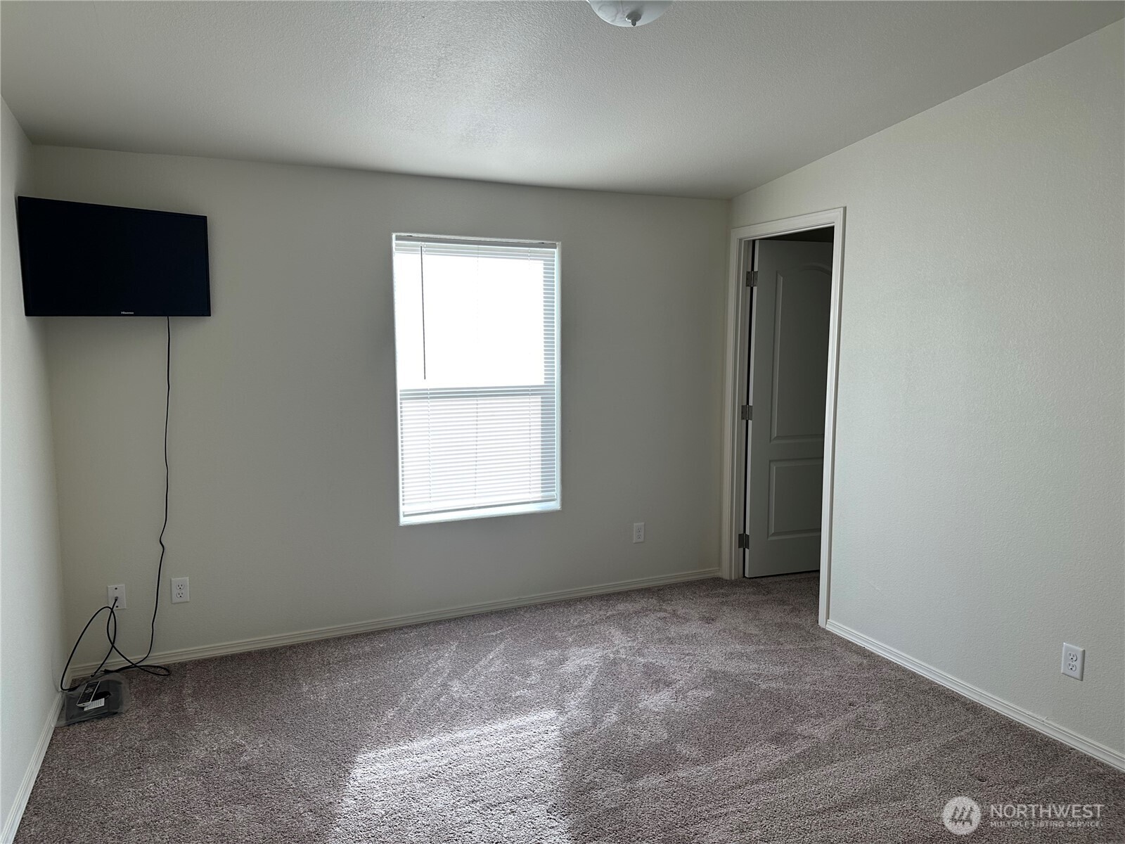 206 Mossyrock Road West Mossyrock, WA 98564 - Photo 6 of 24 an empty room with a flat screen tv and a window