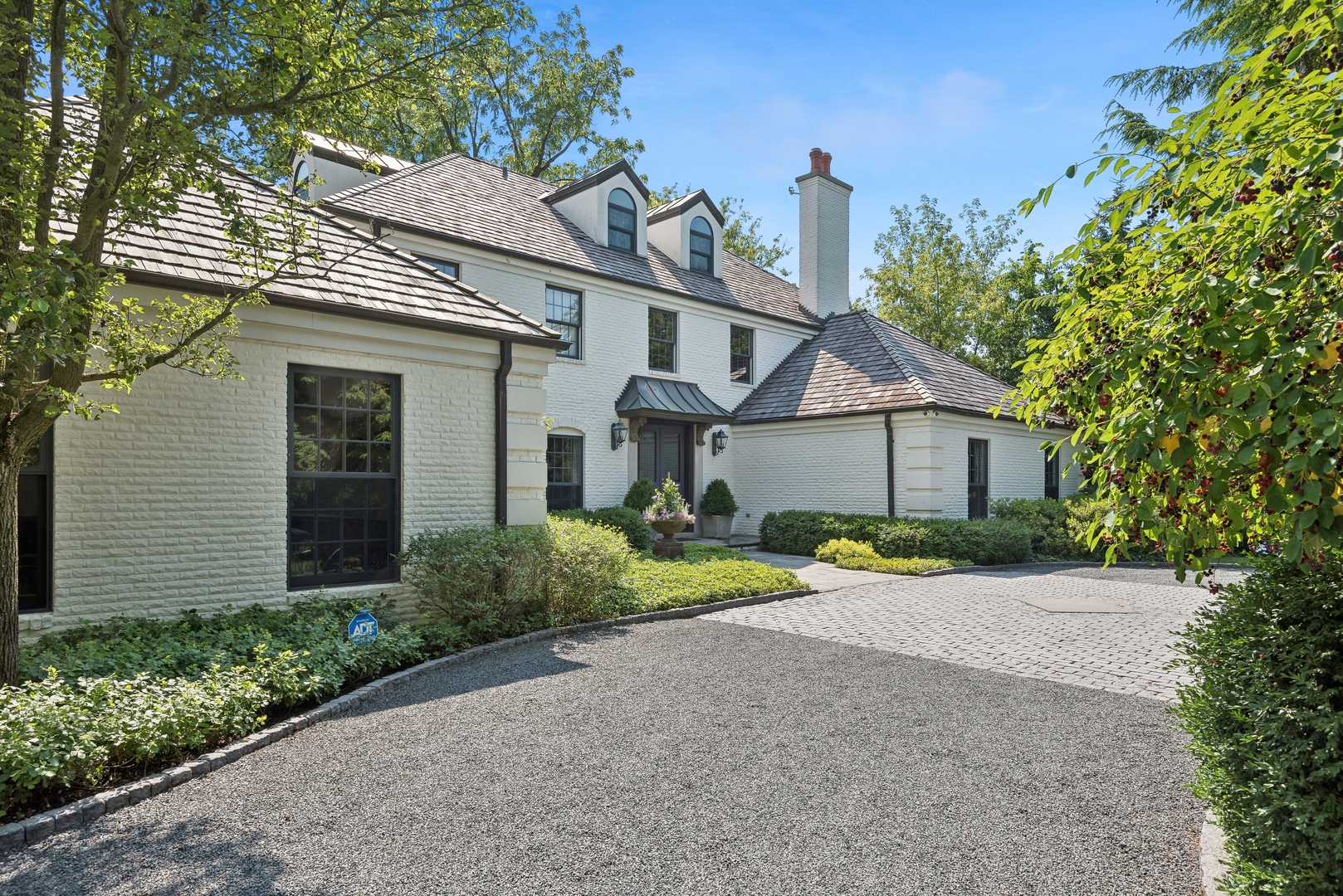 89 North Indian Hill Road Winnetka, IL 60093 - Photo 2 of 91 a front view of a house with a yard and a garage