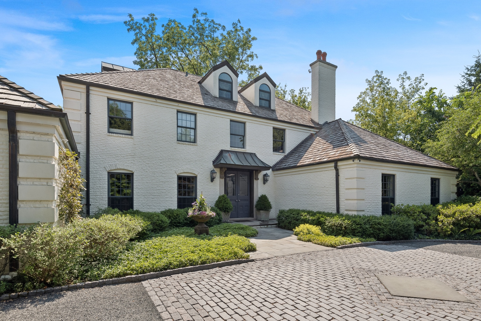 89 North Indian Hill Road Winnetka, IL 60093 - Photo 3 of 91 a front view of a house with a yard