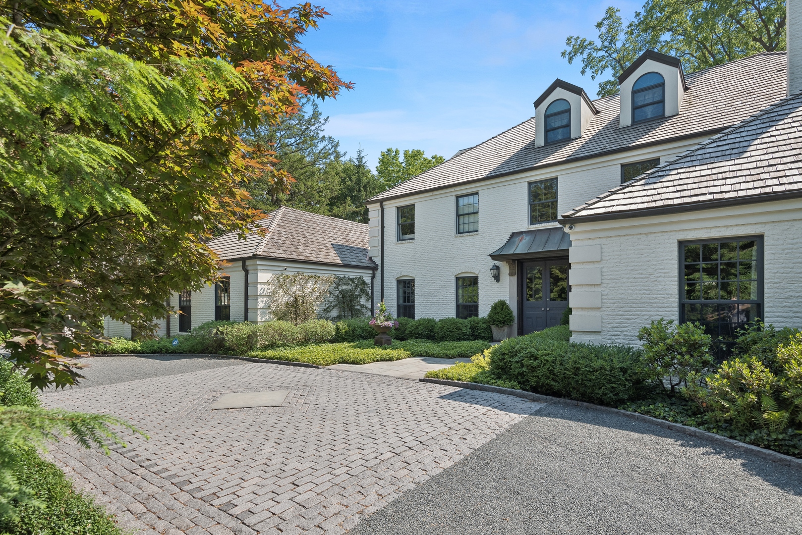 89 North Indian Hill Road Winnetka, IL 60093 - Photo 4 of 91 a front view of a house with a yard and a garage