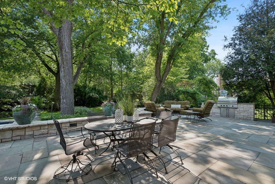 89 North Indian Hill Road Winnetka, IL 60093 - Photo 76 of 91 a view of a patio with table and chairs and potted plants and large tree