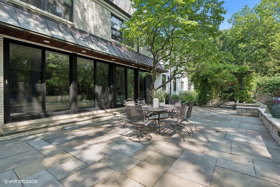 89 North Indian Hill Road Winnetka, IL 60093 - Photo 77 of 91 a view of a patio with table and chairs and floor to ceiling window