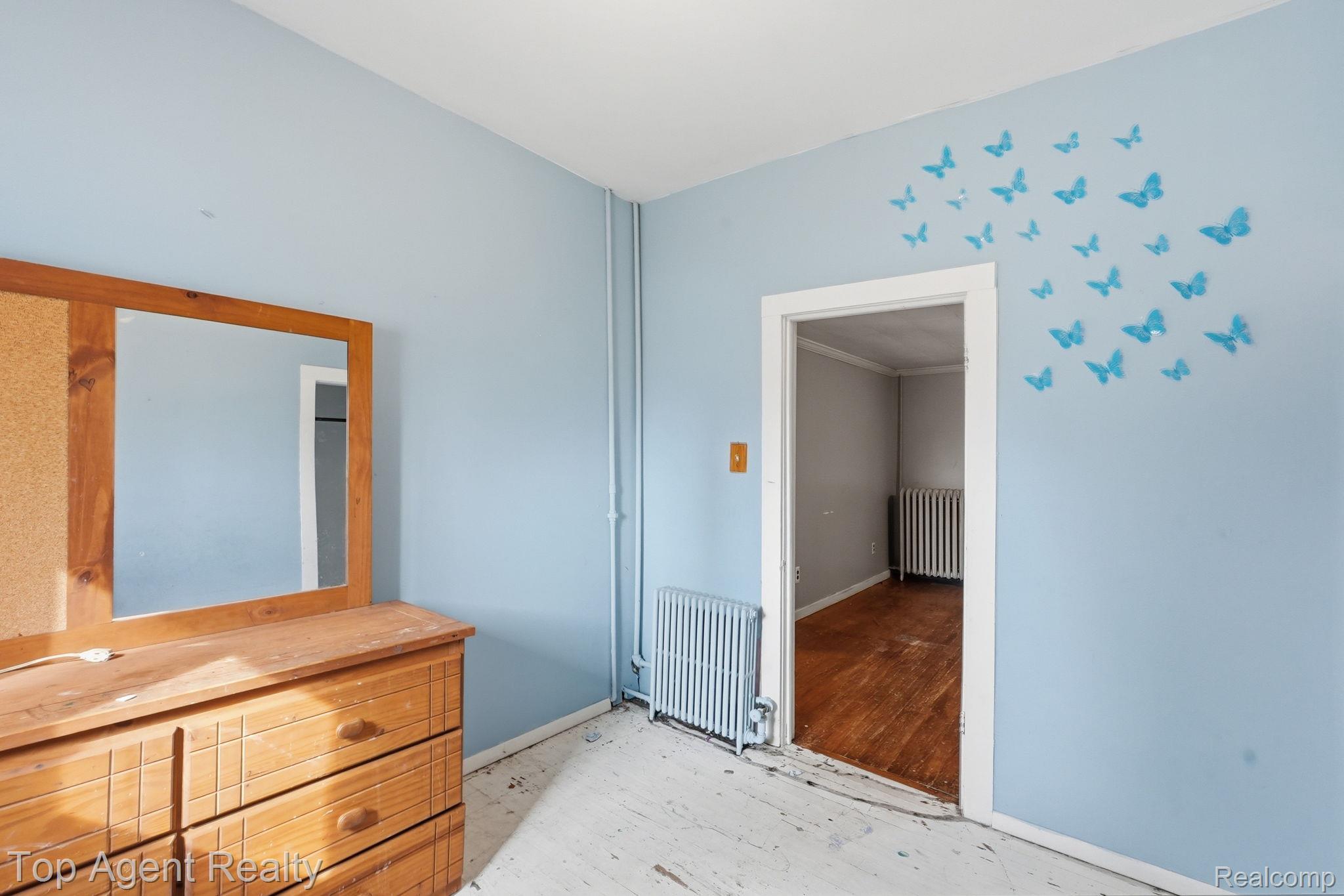 95 West Lapeer Road Peck, MI 48466 - Photo 14 of 33 Unfurnished bedroom featuring radiator heating unit and light wood-style flooring