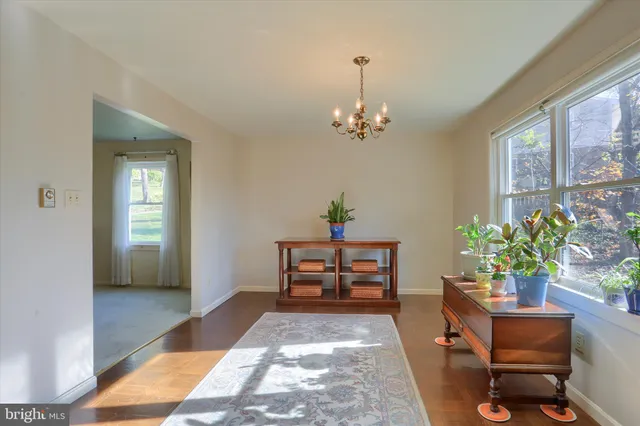 a dining room with furniture a livingroom and chandelier