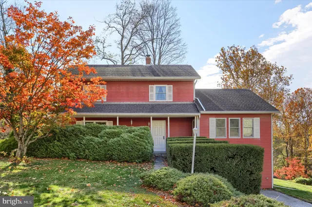 front view of a house with a tree