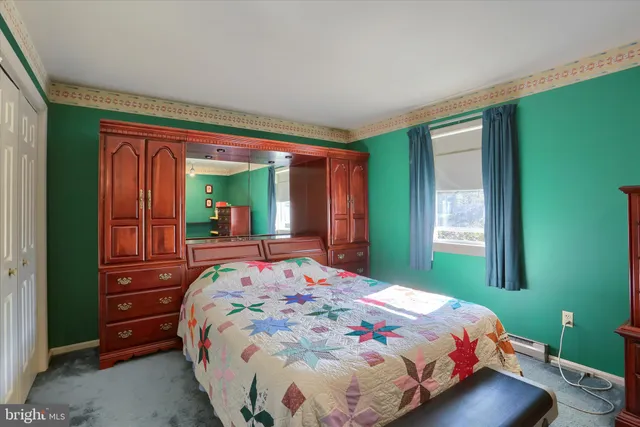 a bedroom with a bed and a mirror