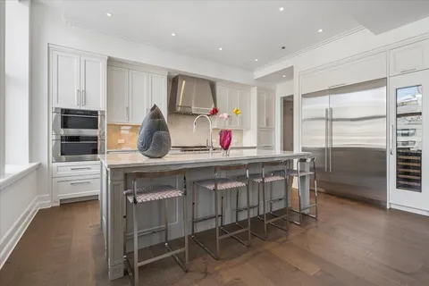 a kitchen that has a lot of cabinets a sink and a stove in it