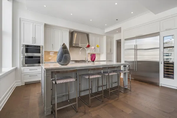 a kitchen that has a lot of cabinets a sink and a stove in it