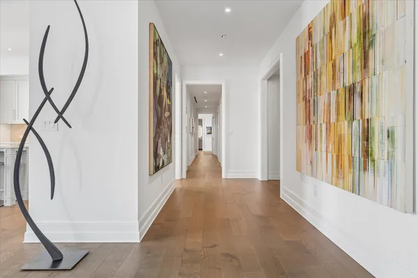 a view of a hallway with wooden floor