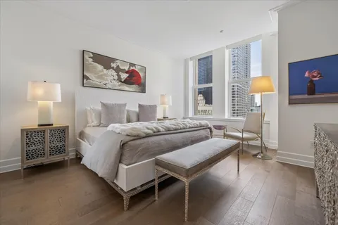 a bedroom with a bed and a wall painting