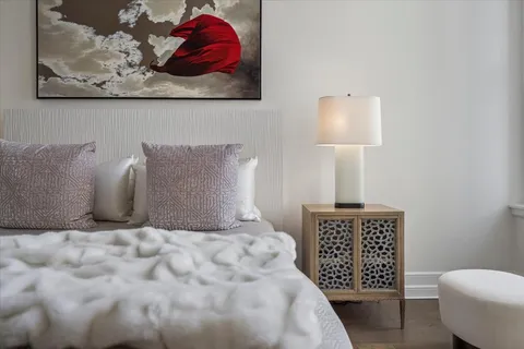 a spacious bathroom with double sink a large mirror and a bathtub
