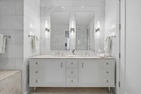 a bathroom with a granite countertop toilet a sink and shower