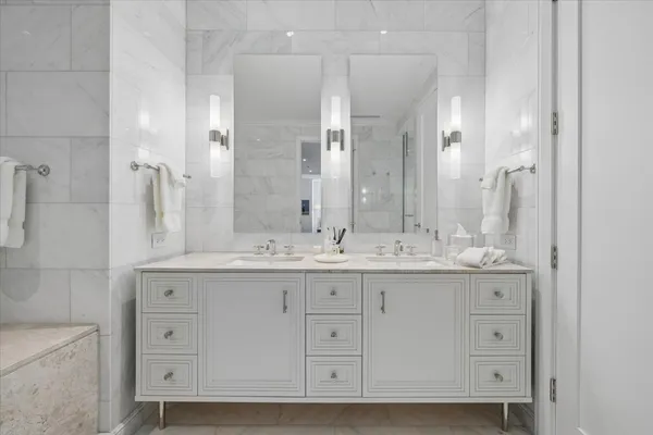 a bathroom with a granite countertop toilet a sink and shower