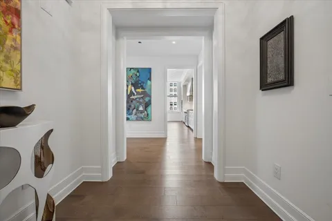 a view of an entryway with wooden floor