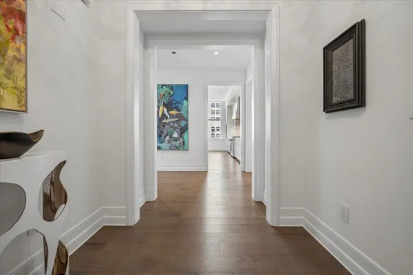 a view of an entryway with wooden floor