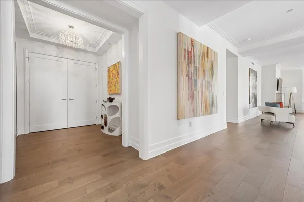 a view of empty room with wooden floor and bathroom