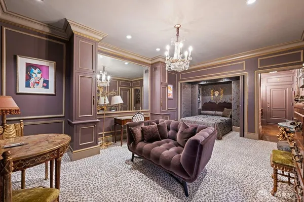 a living room with furniture a dining table and a chandelier