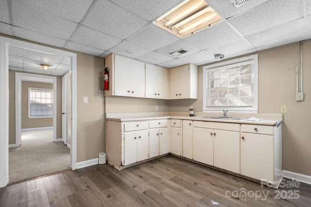 a kitchen with granite countertop white cabinets and white appliances