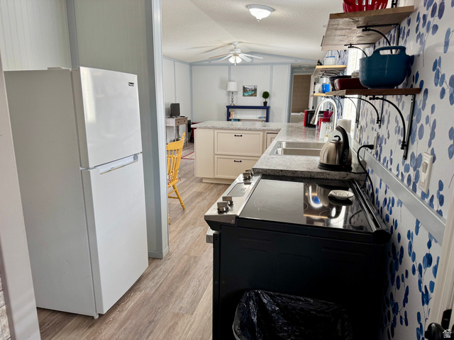 972 Ridgeway Loop, Unit 228 Garden City, UT 84028 - Photo 10 of 26 Kitchen with black electric range oven, freestanding refrigerator, open shelves