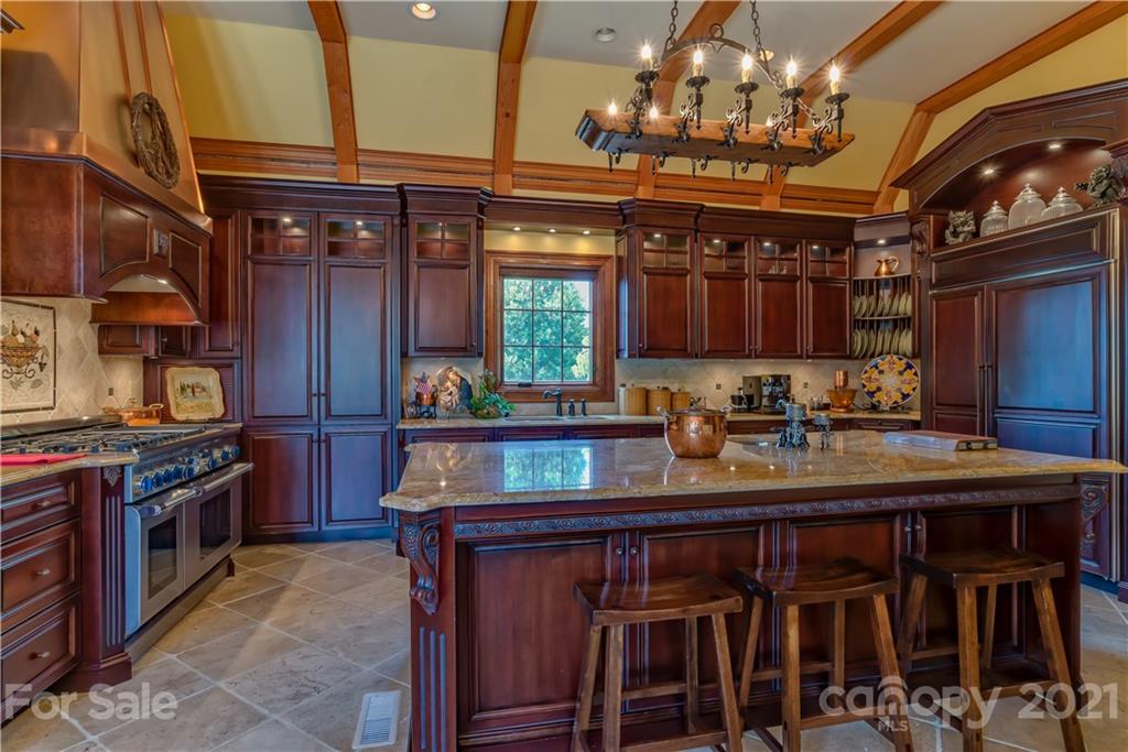 383 Silver Ridge Road Mill Spring, NC 28756 - Photo 12 of 46 a kitchen with kitchen island granite countertop a sink and a stove