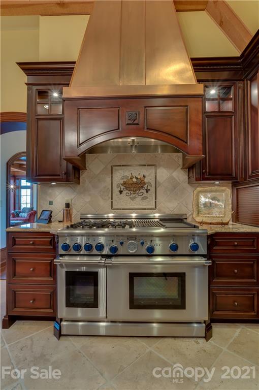 383 Silver Ridge Road Mill Spring, NC 28756 - Photo 15 of 46 a stove top oven sitting inside of a kitchen