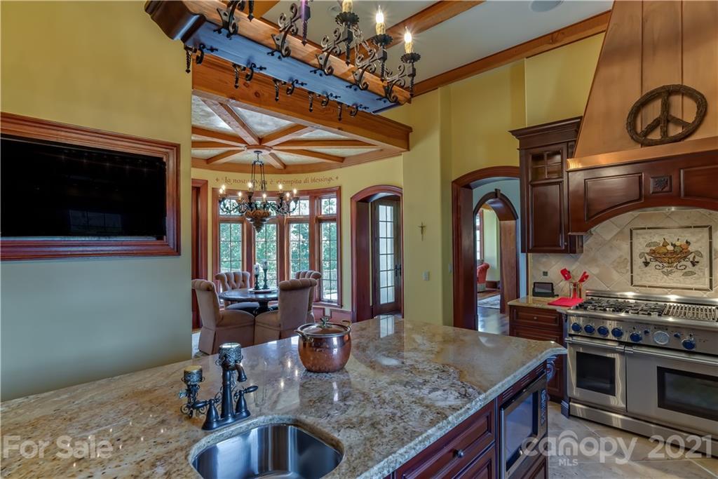 383 Silver Ridge Road Mill Spring, NC 28756 - Photo 16 of 46 a kitchen with stainless steel appliances granite countertop a sink and a stove