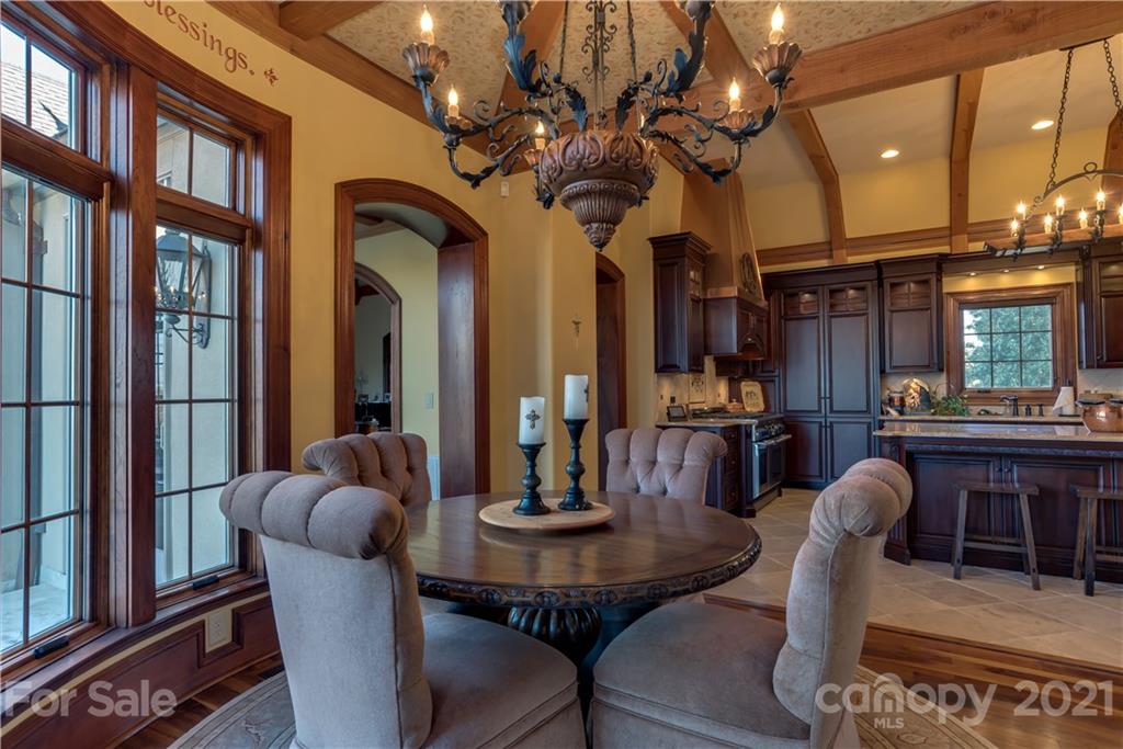 383 Silver Ridge Road Mill Spring, NC 28756 - Photo 18 of 46 a dining room with furniture a chandelier and a large window