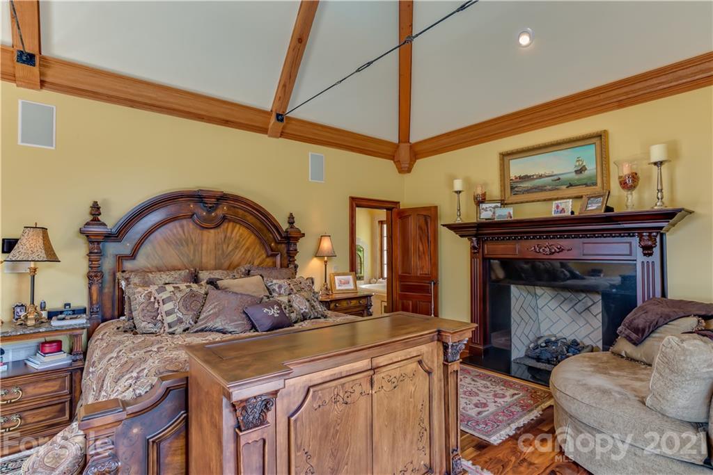 383 Silver Ridge Road Mill Spring, NC 28756 - Photo 20 of 46 a bed room with a bed and a fireplace