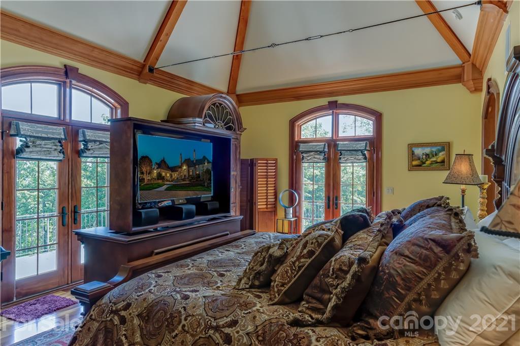 383 Silver Ridge Road Mill Spring, NC 28756 - Photo 23 of 46 a bedroom with a bed and a large window