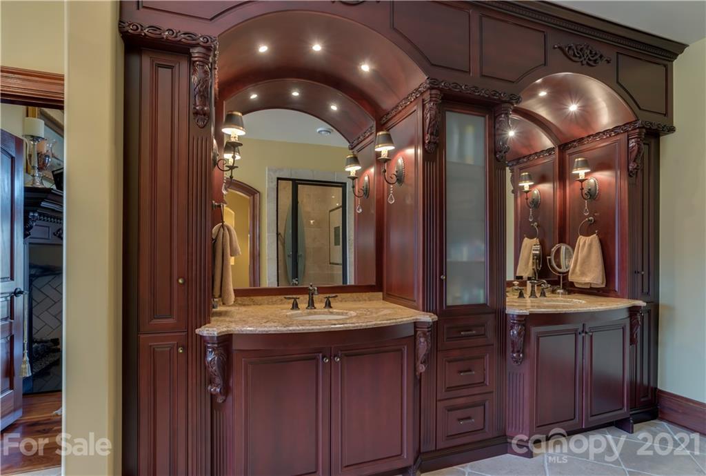 383 Silver Ridge Road Mill Spring, NC 28756 - Photo 25 of 46 a bathroom with a sink and a mirror