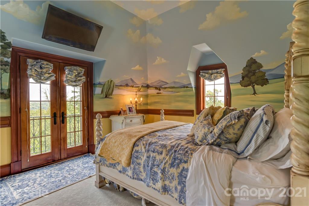 383 Silver Ridge Road Mill Spring, NC 28756 - Photo 26 of 46 a bed sitting in a bedroom next to a large window