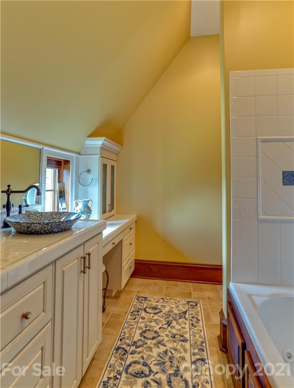 383 Silver Ridge Road Mill Spring, NC 28756 - Photo 27 of 46 a bathroom with sink and mirror
