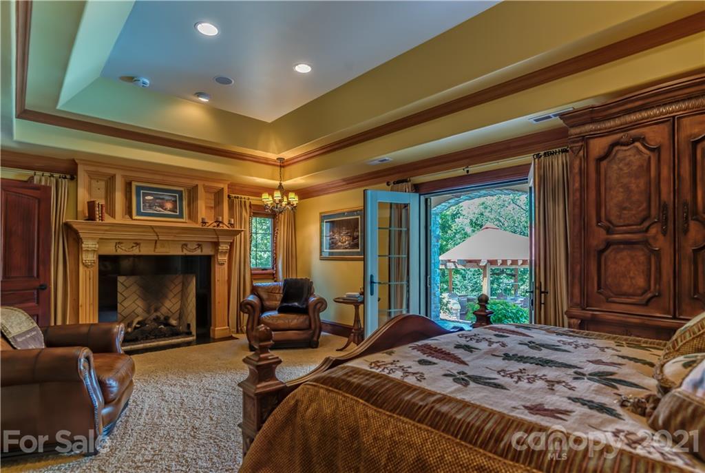 383 Silver Ridge Road Mill Spring, NC 28756 - Photo 28 of 46 a bed sitting in a spacious bedroom next to a window