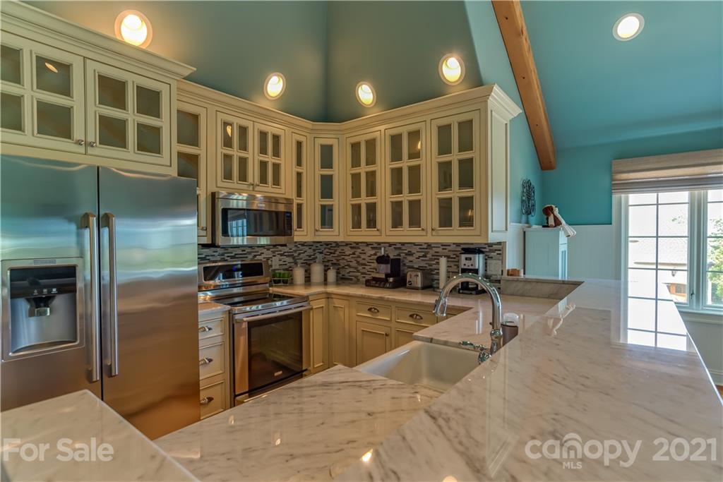 383 Silver Ridge Road Mill Spring, NC 28756 - Photo 36 of 46 a kitchen with a sink stainless steel appliances and cabinets
