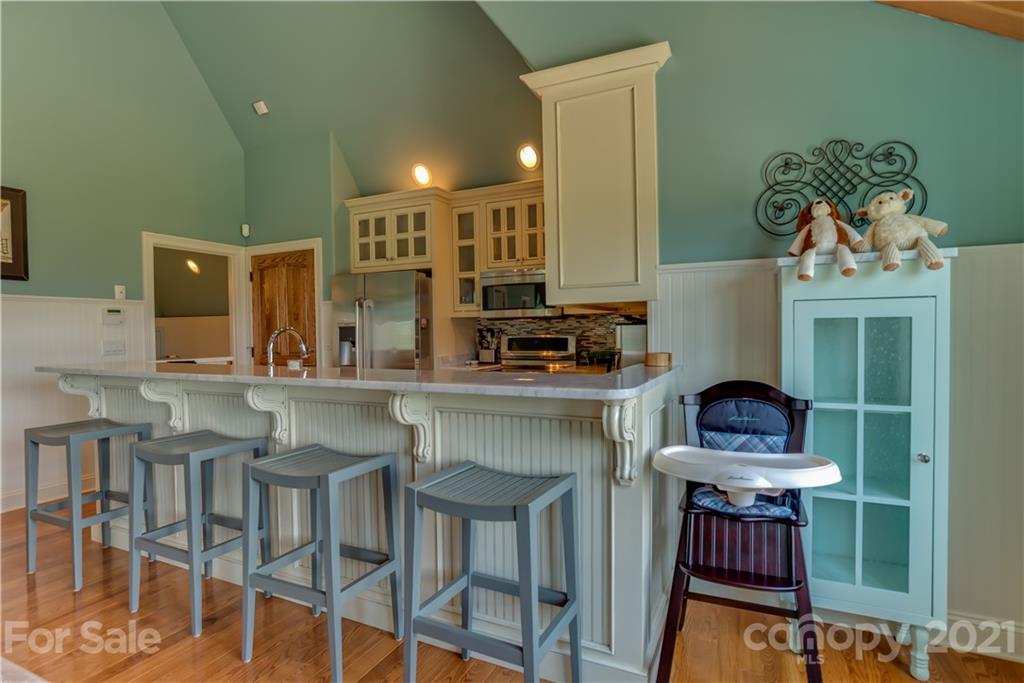 383 Silver Ridge Road Mill Spring, NC 28756 - Photo 37 of 46 a kitchen with stainless steel appliances granite countertop a stove a sink and a refrigerator