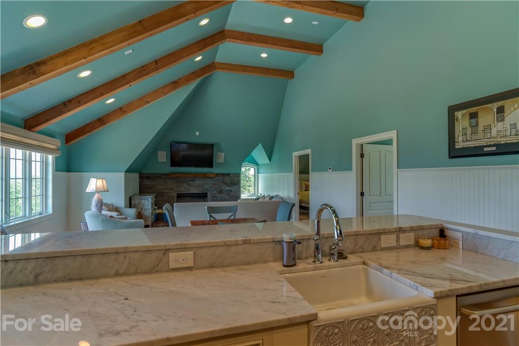 383 Silver Ridge Road Mill Spring, NC 28756 - Photo 38 of 46 a kitchen with a sink and a stove with wooden floor