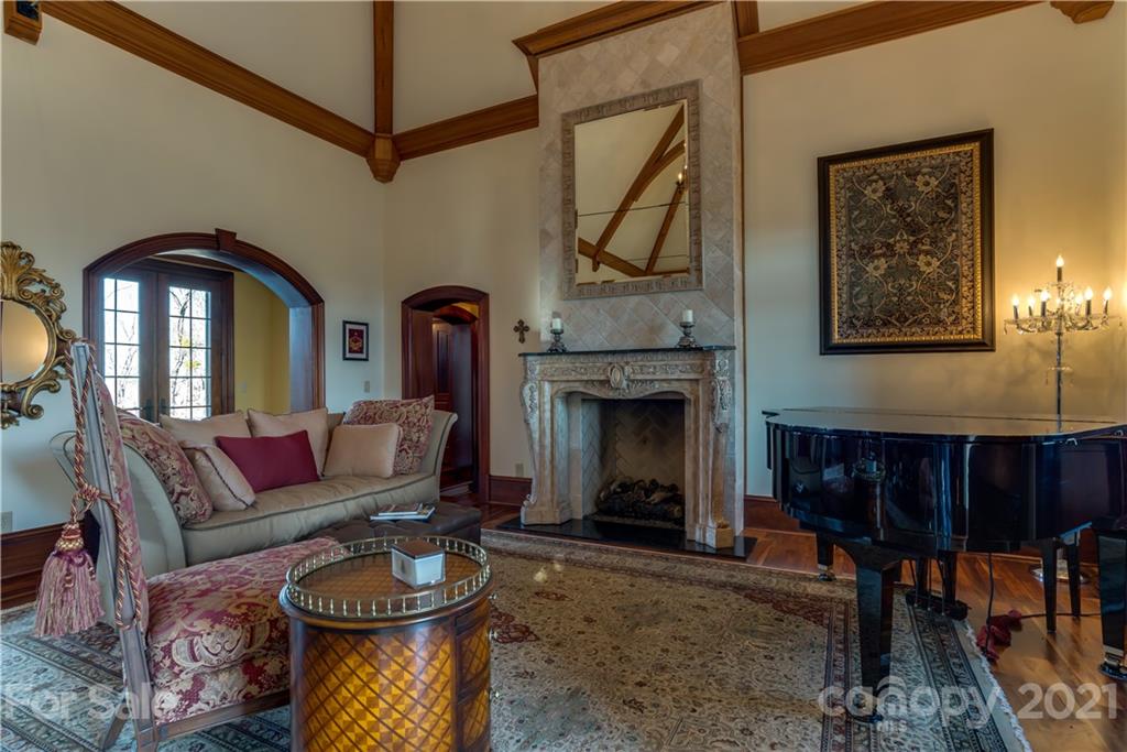 383 Silver Ridge Road Mill Spring, NC 28756 - Photo 8 of 46 a living room with furniture a rug and a fireplace