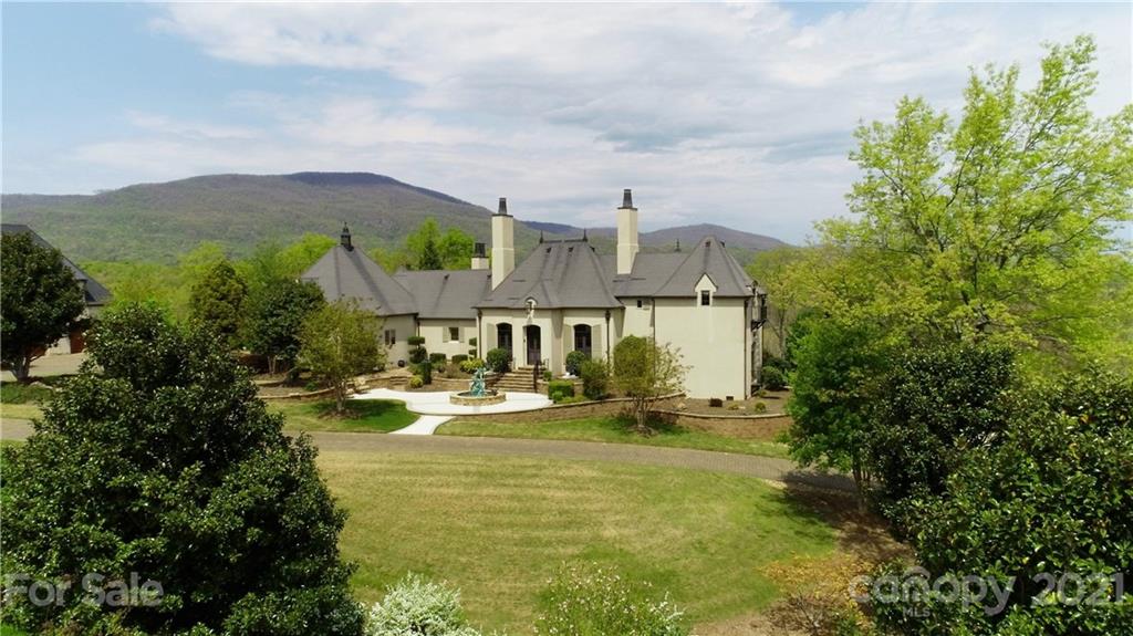 383 Silver Ridge Road Mill Spring, NC 28756 - Photo 9 of 46 a view of a house with garden and mountains