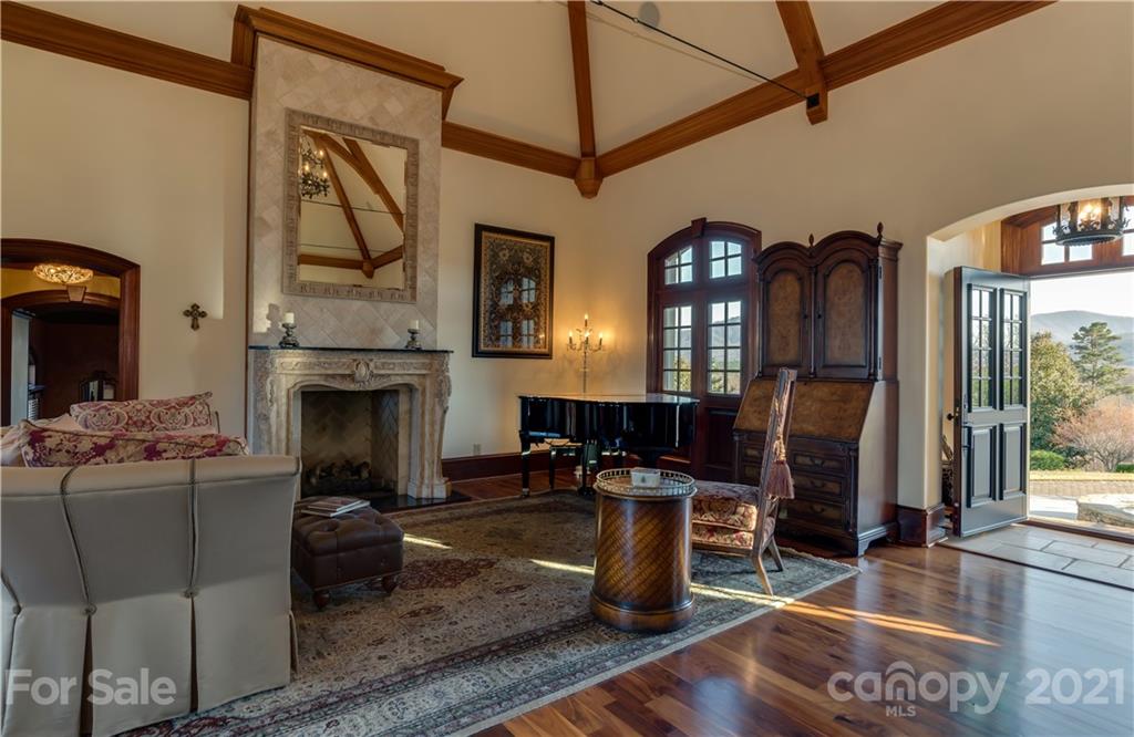 383 Silver Ridge Road Mill Spring, NC 28756 - Photo 10 of 46 a living room with furniture a flat screen tv and a fireplace