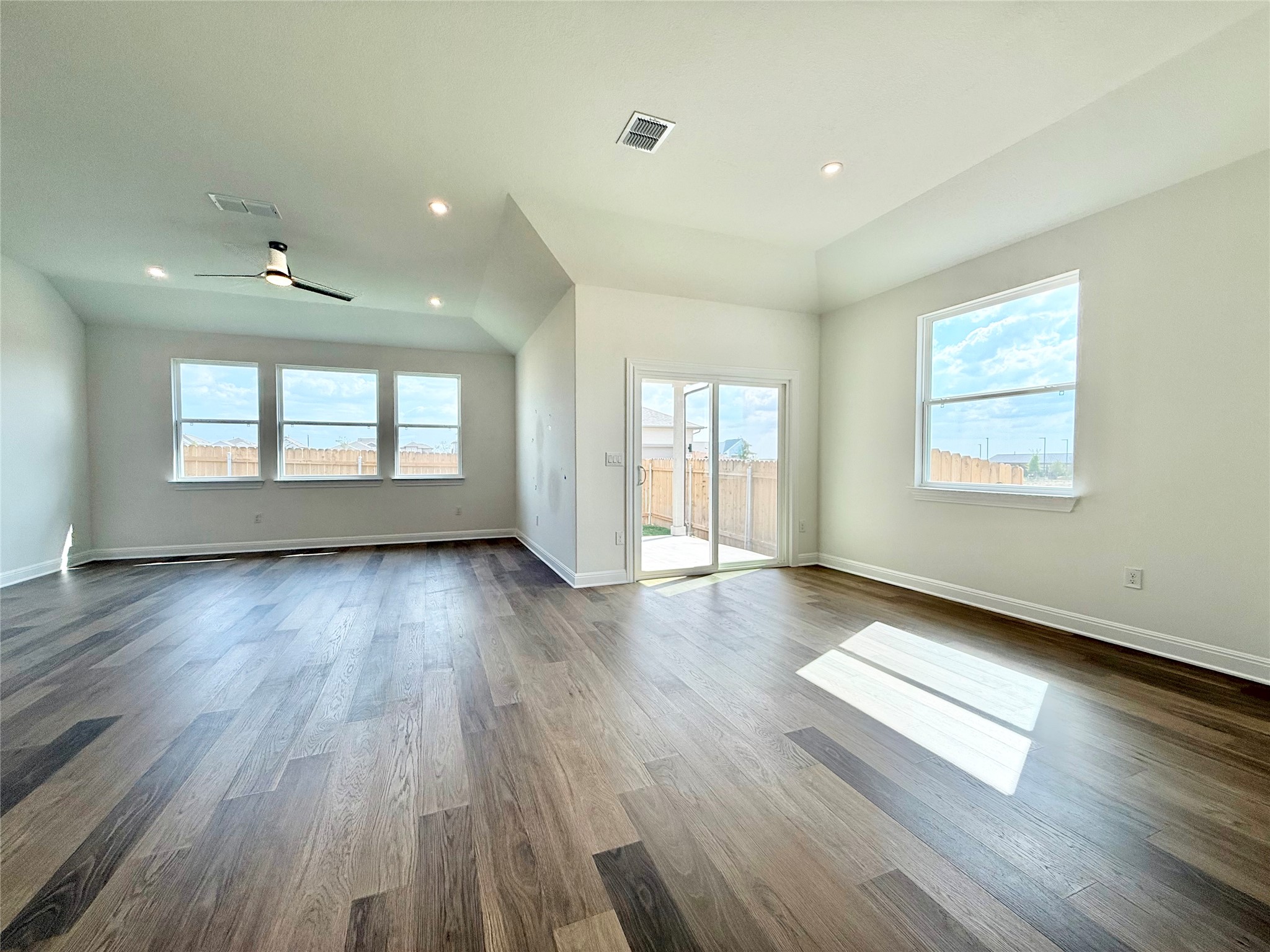 461 Young Street Buda, TX 78610 - Photo 11 of 32 a view of an empty room with wooden floor and a window