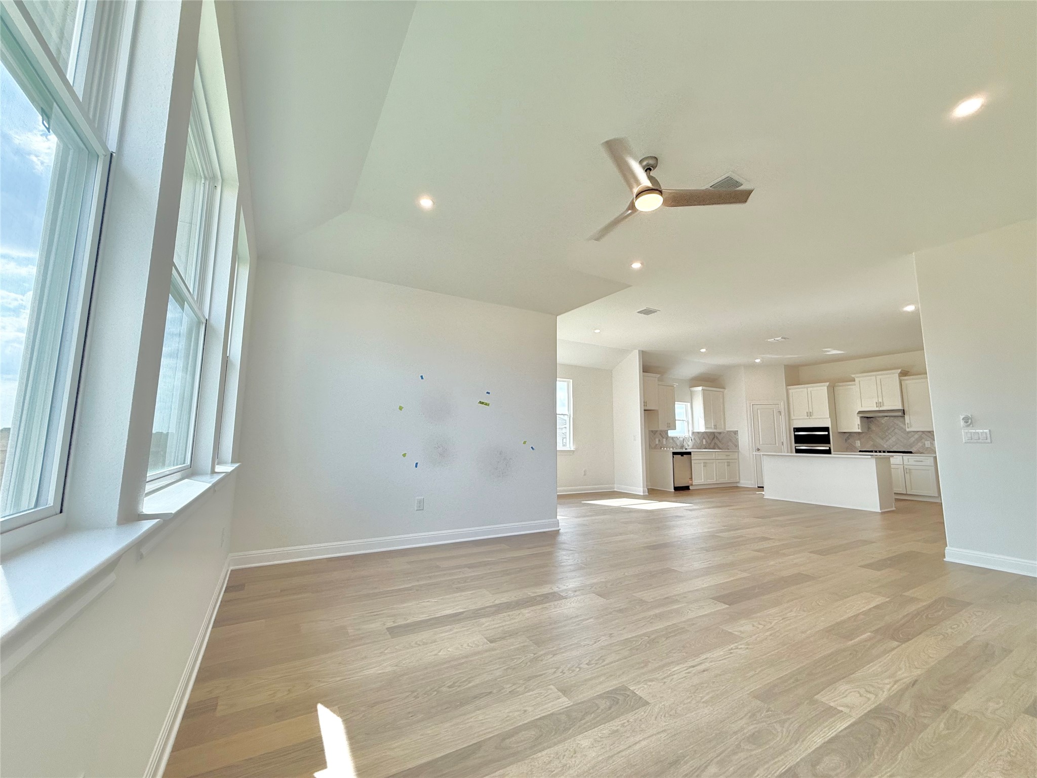 461 Young Street Buda, TX 78610 - Photo 13 of 32 a view of an empty room and a kitchen