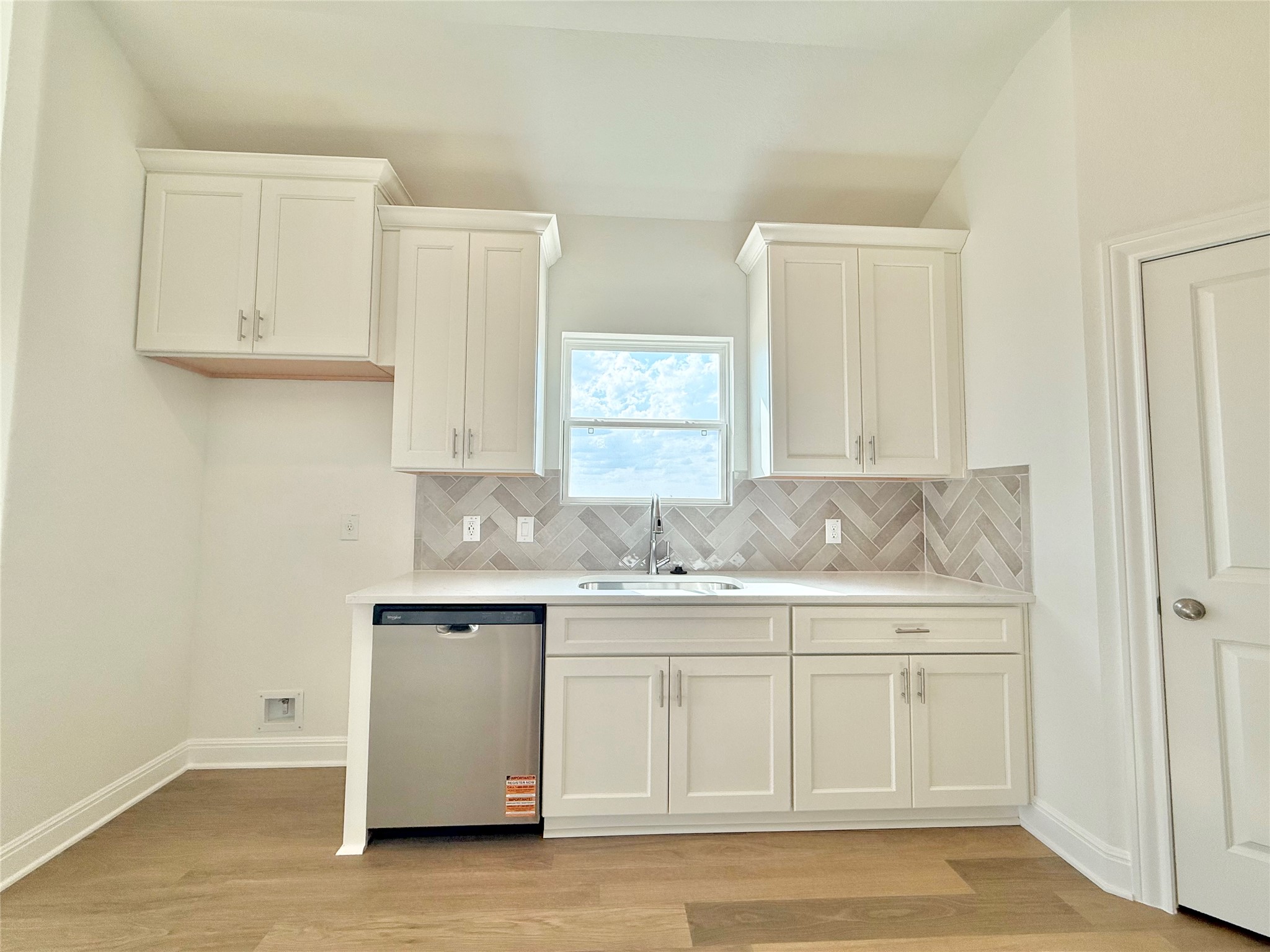 461 Young Street Buda, TX 78610 - Photo 14 of 32 a kitchen with white cabinets and sink
