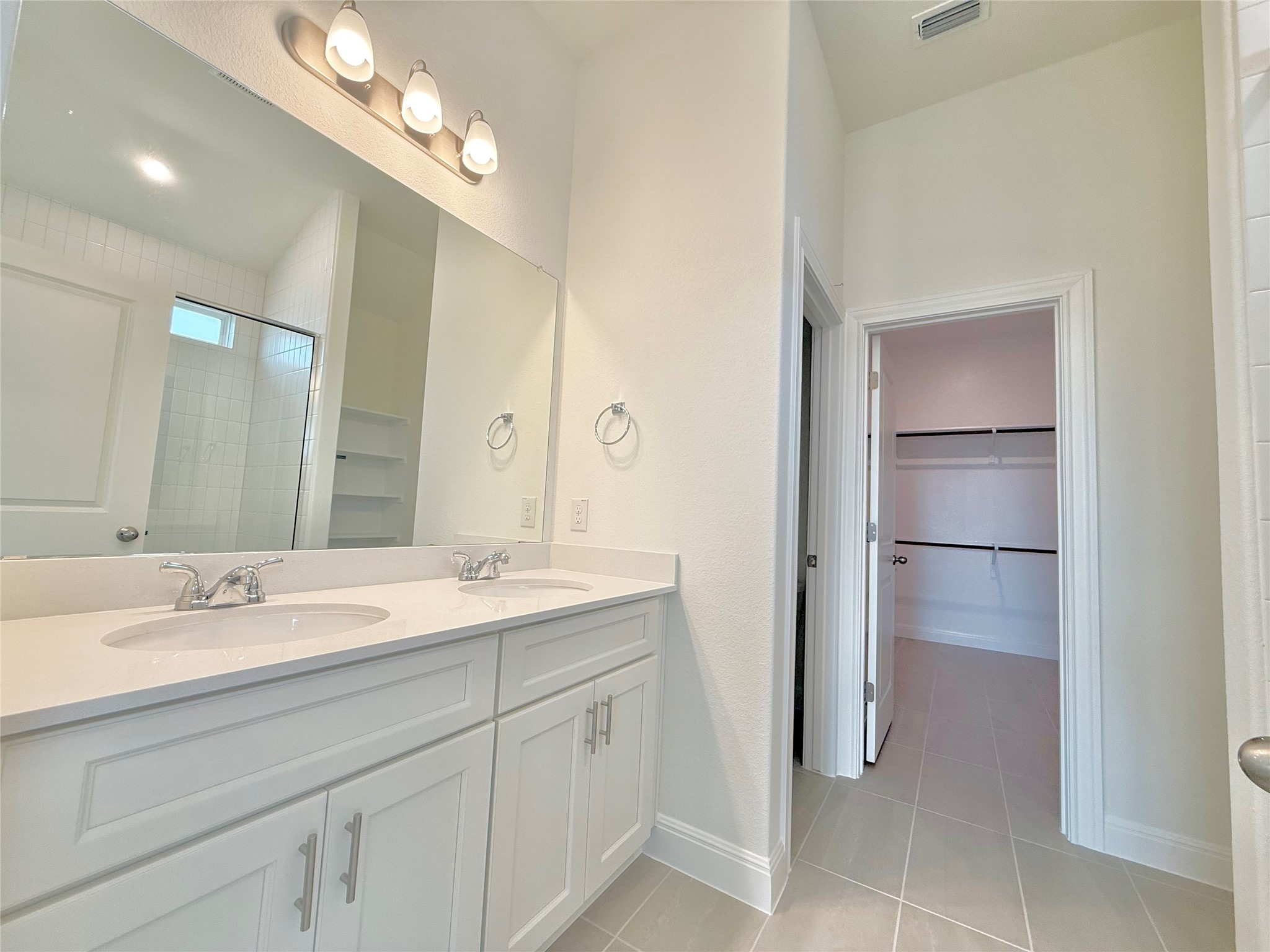461 Young Street Buda, TX 78610 - Photo 18 of 32 a bathroom with a sink a vanity and a mirror