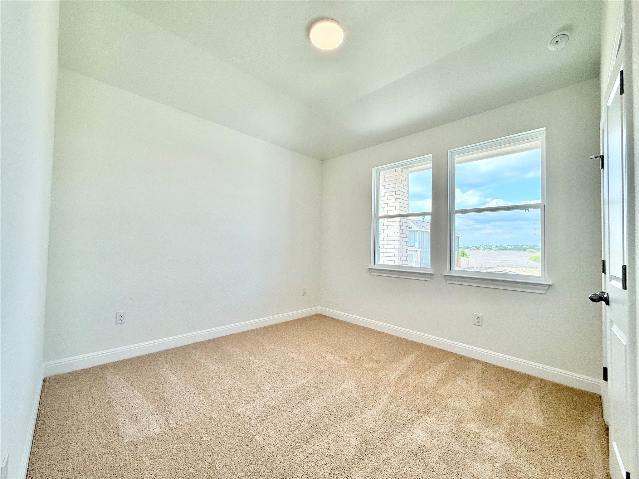 461 Young Street Buda, TX 78610 - Photo 3 of 32 an empty room with windows