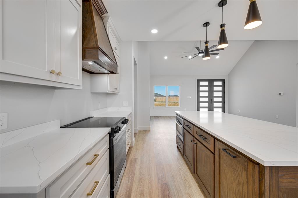 406 Private Road Brookston, TX 75421 - Photo 12 of 37 a kitchen with stainless steel appliances a sink a stove and a wooden floors