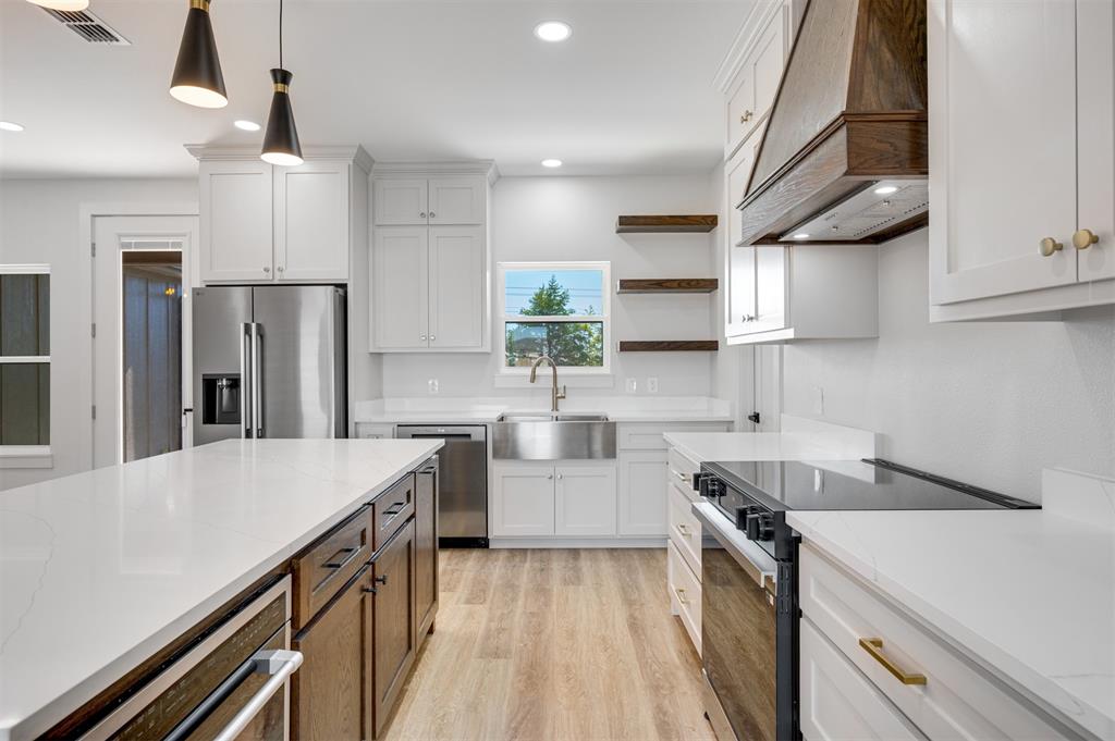 406 Private Road Brookston, TX 75421 - Photo 13 of 37 a kitchen with stainless steel appliances a sink stove and refrigerator