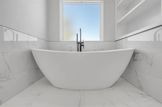 a white bath tub sitting in a bathroom