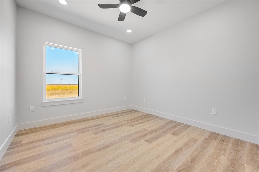 406 Private Road Brookston, TX 75421 - Photo 24 of 37 an empty room with a window and a ceiling fan