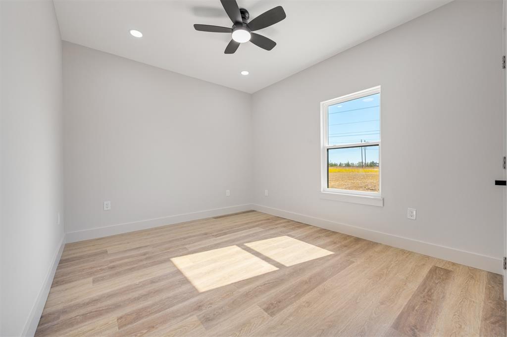 406 Private Road Brookston, TX 75421 - Photo 26 of 37 wooden floor in an empty room with a window