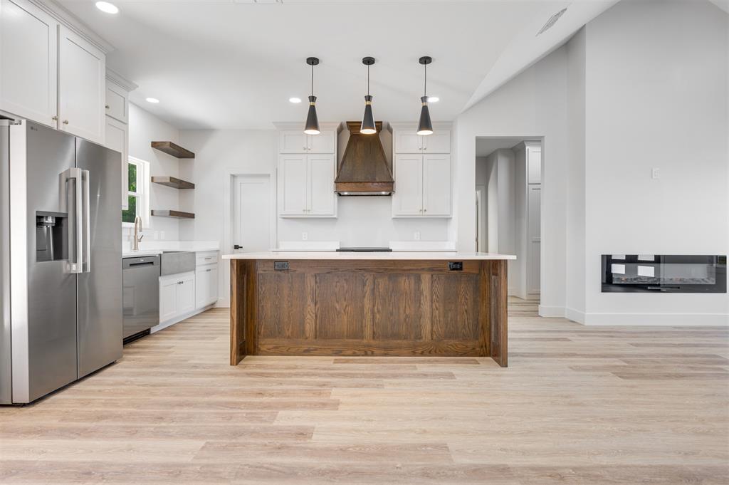 406 Private Road Brookston, TX 75421 - Photo 9 of 37 a large kitchen with stainless steel appliances granite countertop a stove a refrigerator and a sink